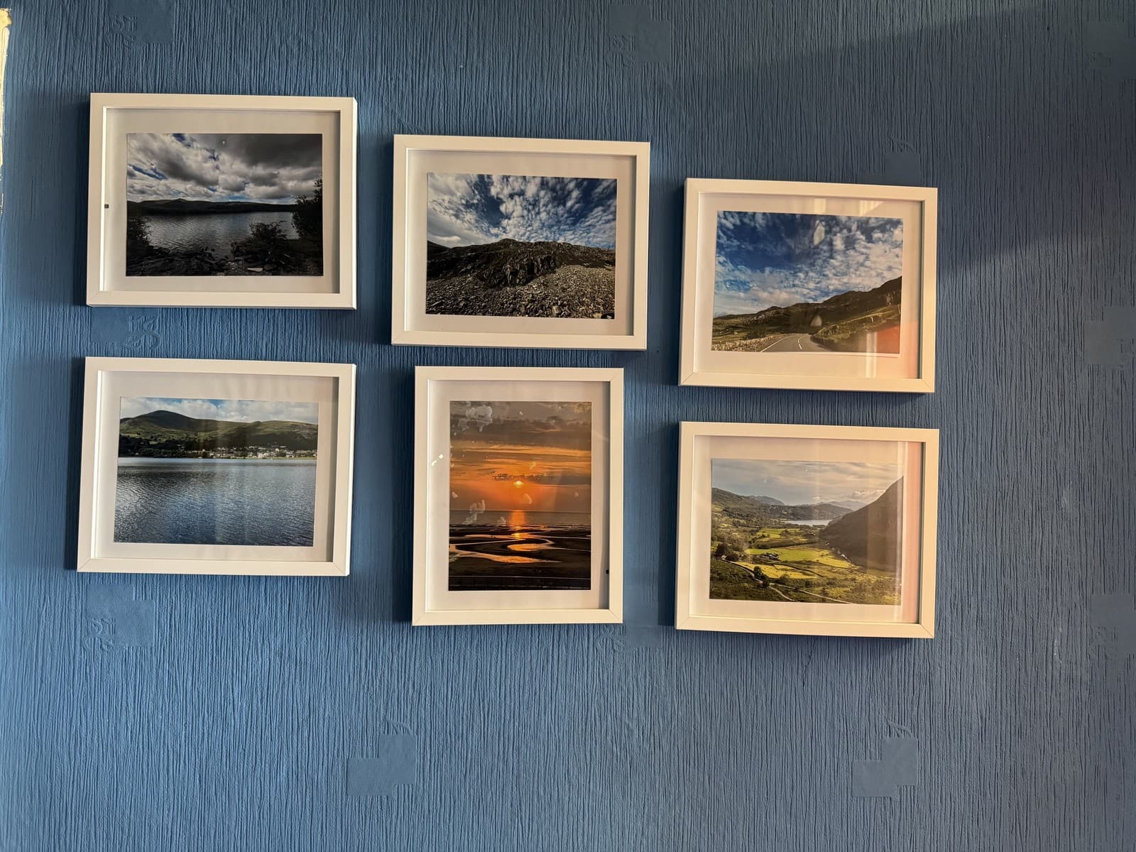 Framed landscape photography in the hallway