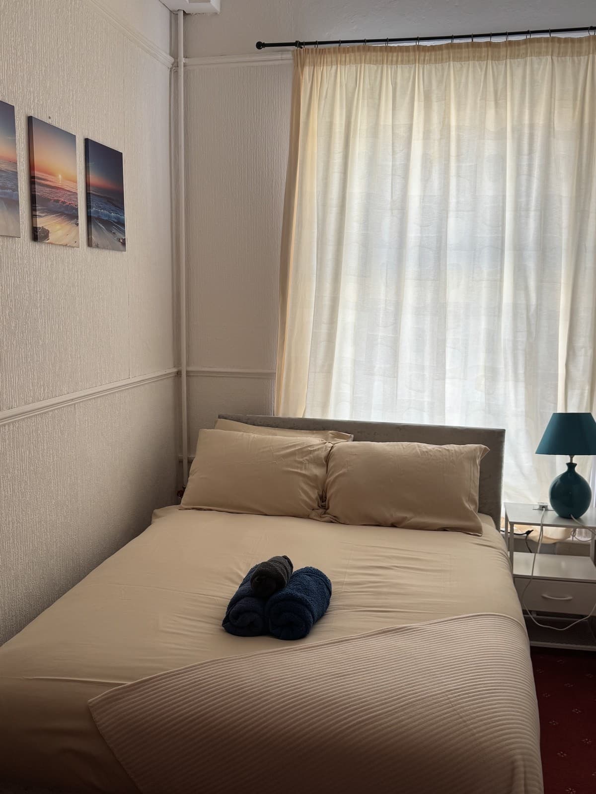 Double room with coastal artwork