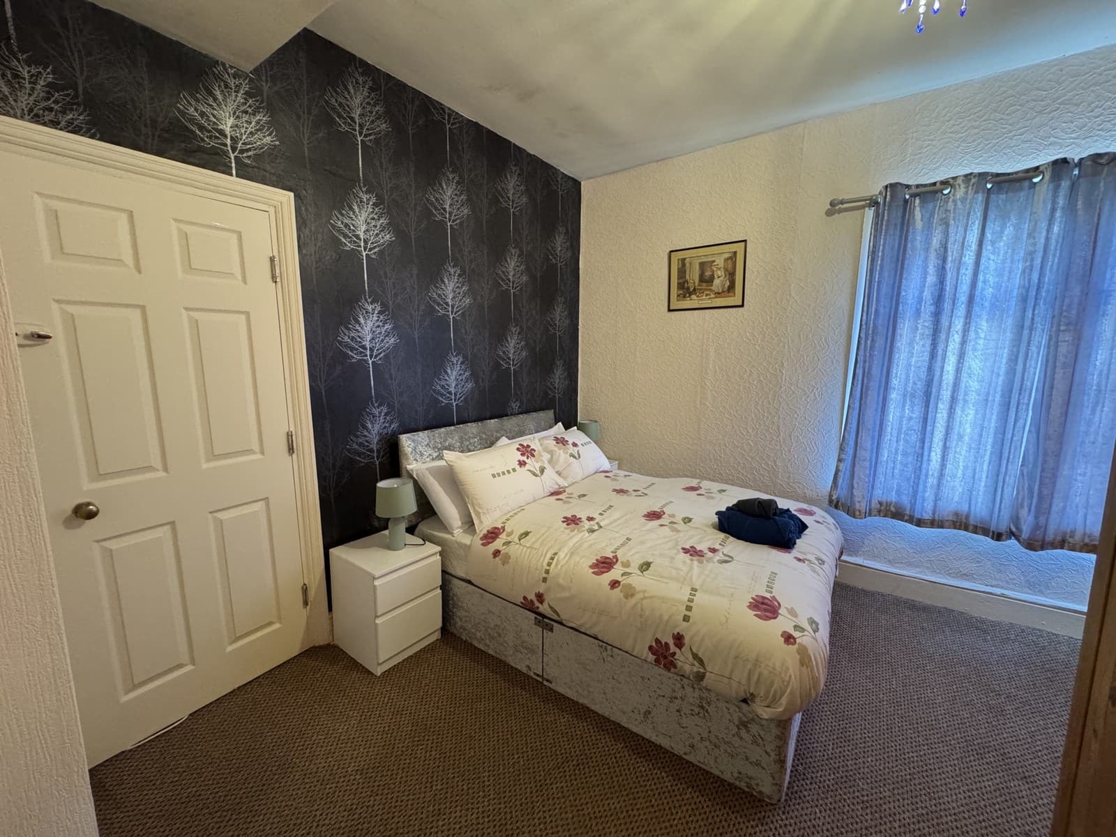 Double room with feature wallpaper